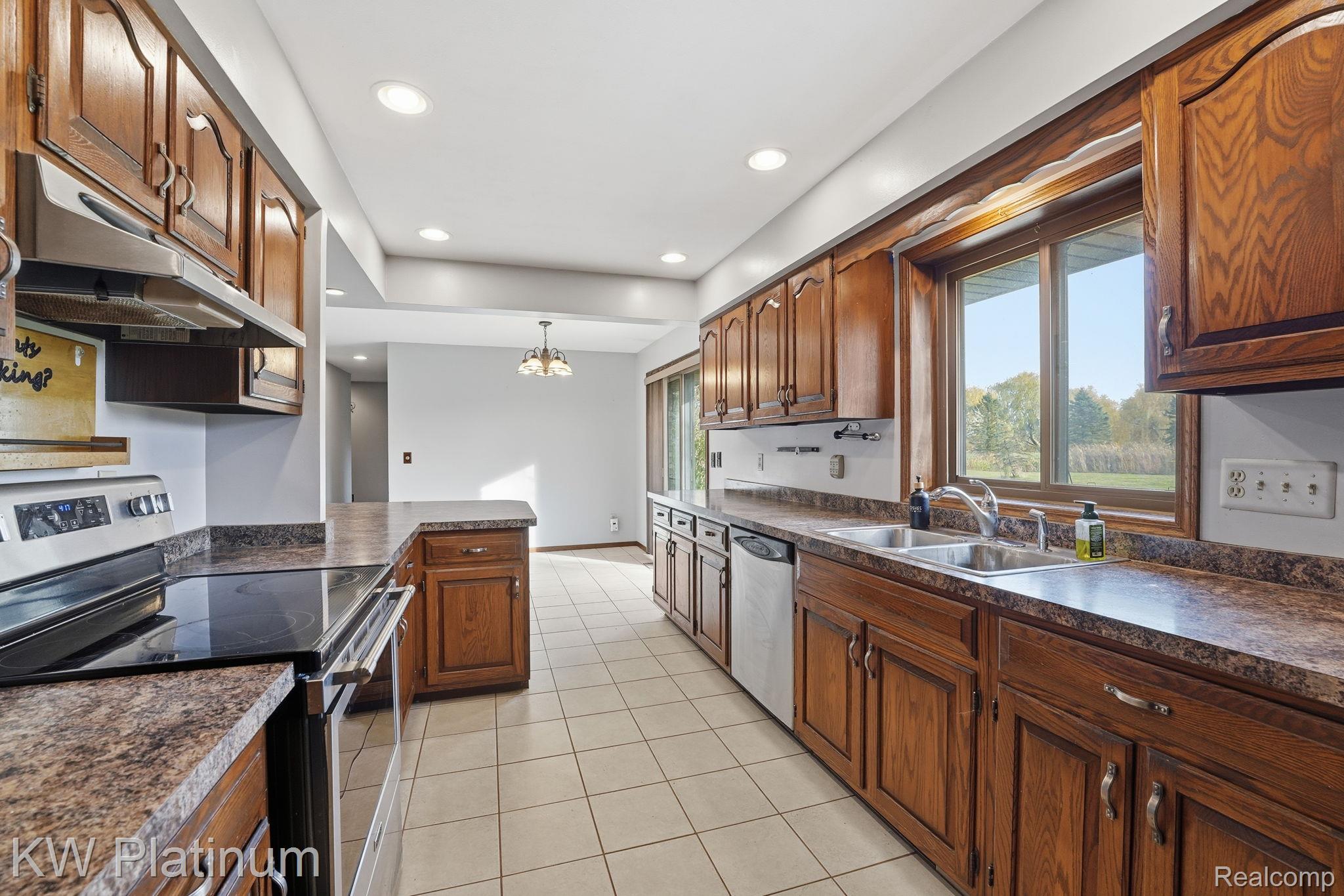 7383 Fisher Road Jeddo, MI 48032 - Photo 8 of 40 Kitchen with dark countertops, stainless steel appliances, plenty of natural light, and recessed lighting