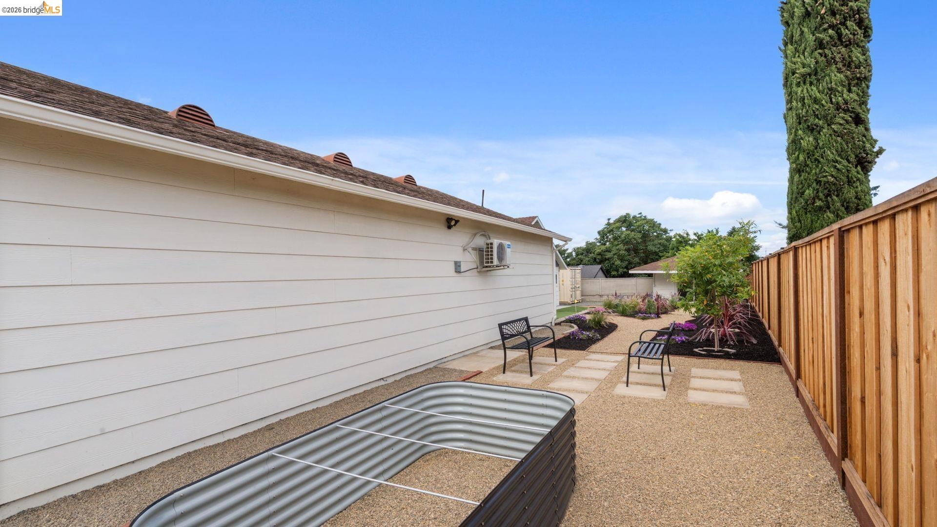 700 Brownstone Road Oakley, CA 94561 - Photo 43 of 58 Expansive side yard featuring gravel landscaping, a raised garden bed, and a new privacy fence