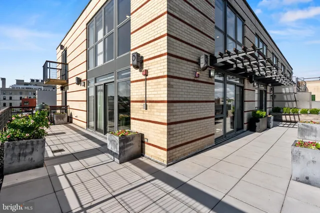 a view of a chairs and tables in the back yard of the building