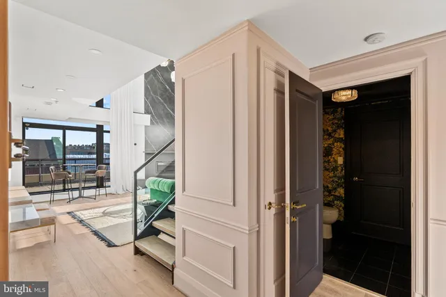 a view of entryway with wooden floor and a livingroom view
