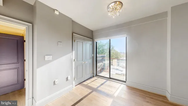 a view of an entryway with wooden floor