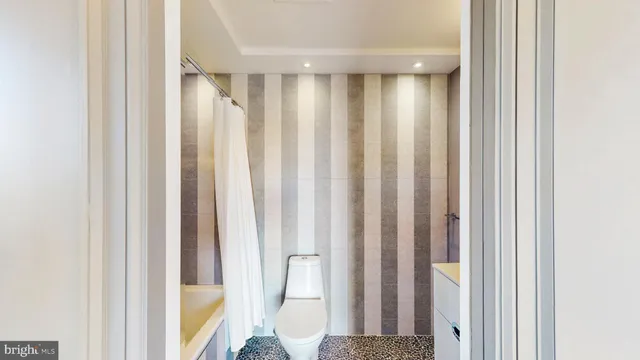 a view of a bathroom with shower and curtain