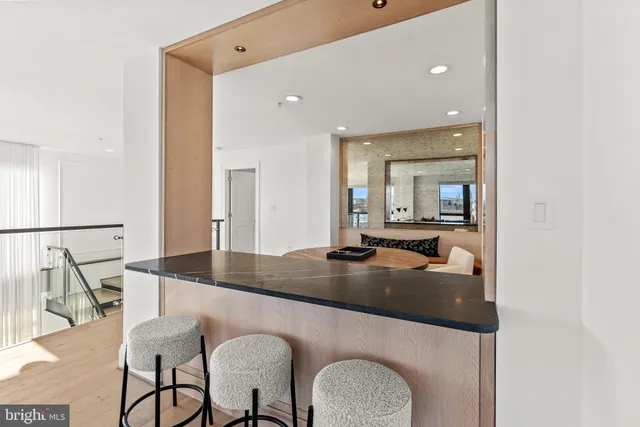 a kitchen with dining table and chairs