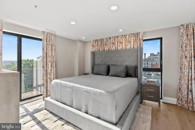 a bedroom with a large bed and a large window