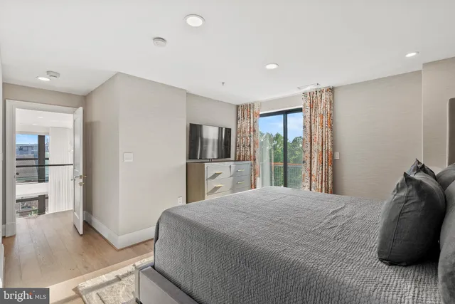 a bedroom with a bed and a view of living room