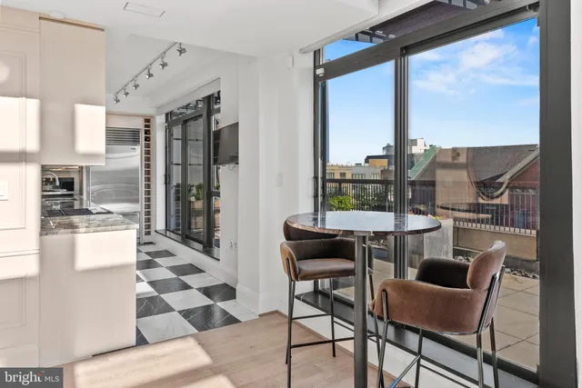 a view of a dining room with furniture a chandelier and wooden floor