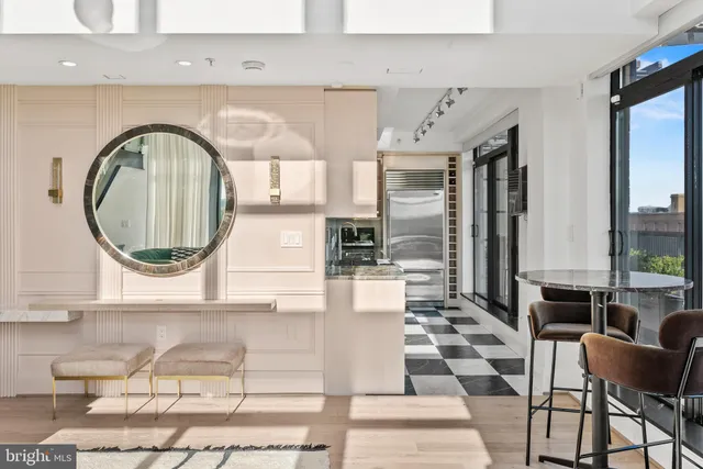 a living room with a black white checkered floor with a swimming pool