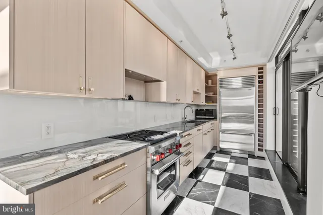 a kitchen with a stove a sink and a refrigerator