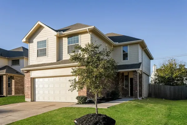 a front view of a house with a garden and plants