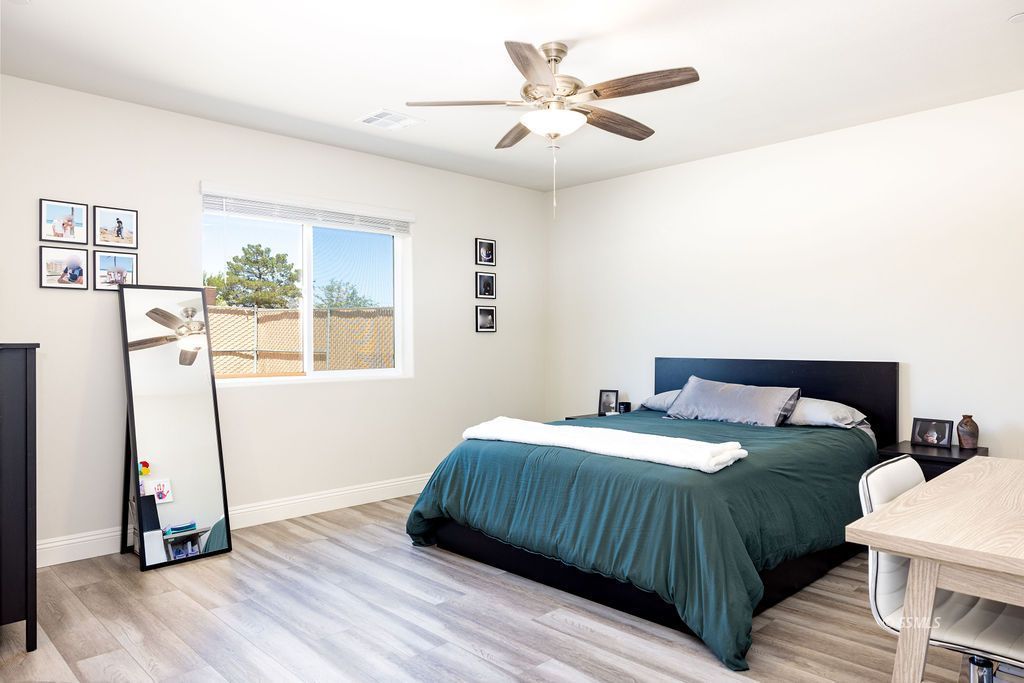 1229 South Ranger Street Ridgecrest, CA 93555 - Photo 20 of 36 a bedroom with a bed and a table