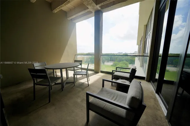a living room with furniture and floor to ceiling windows