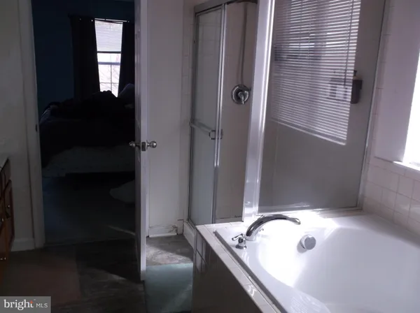 a bathroom with a tub and sink