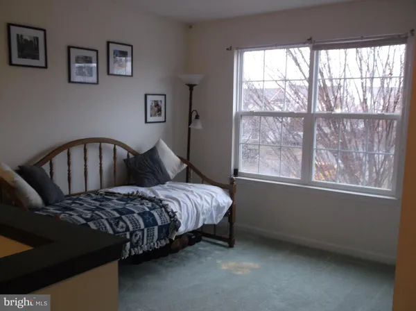 a bedroom with a bed and window