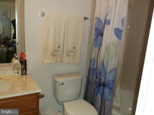 a white toilet sitting next to a bathroom sink