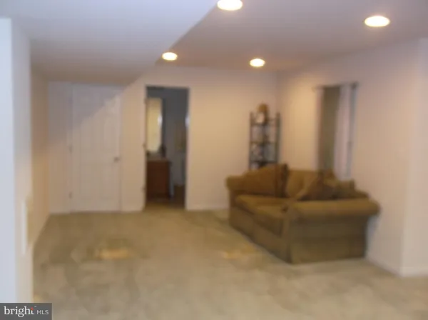a living room with furniture and a walk in closet