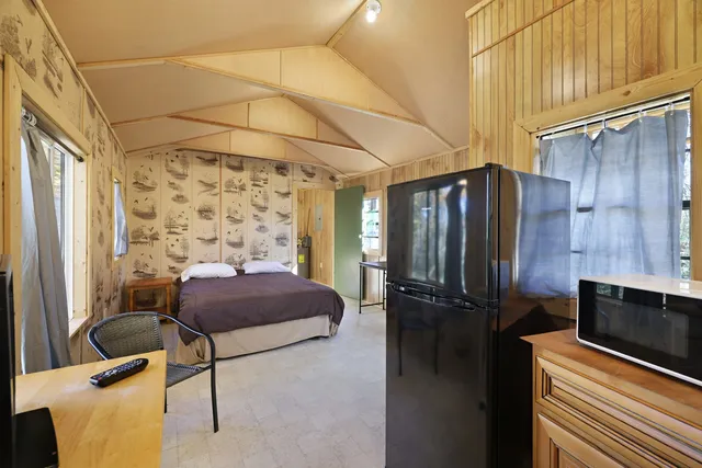 a bedroom with a bed and a mirror