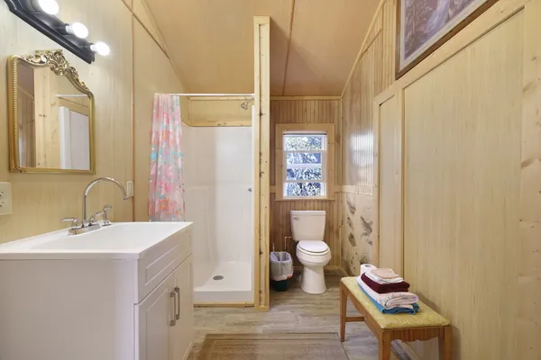 a bathroom with a sink toilet and shower