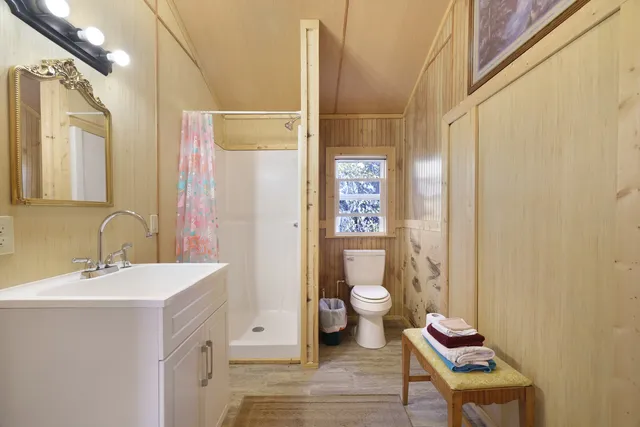 a bathroom with a sink toilet and shower