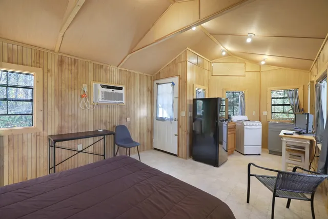 a bedroom with a bed and a chair