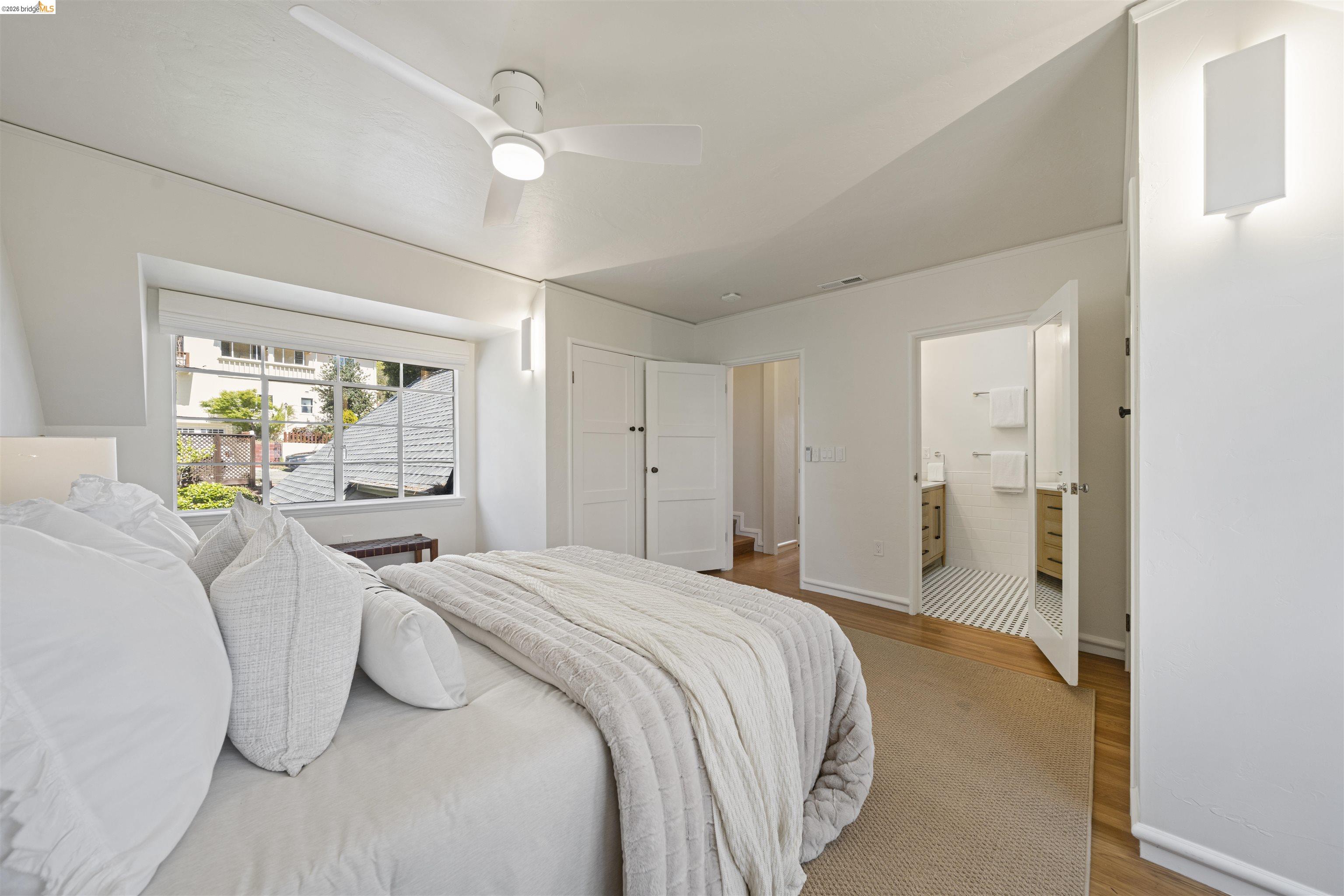 1170 Sterling Avenue Berkeley, CA 94708 - Photo 27 of 52 Bedroom featuring wood finished floors, a ceiling fan, and connected bathroom