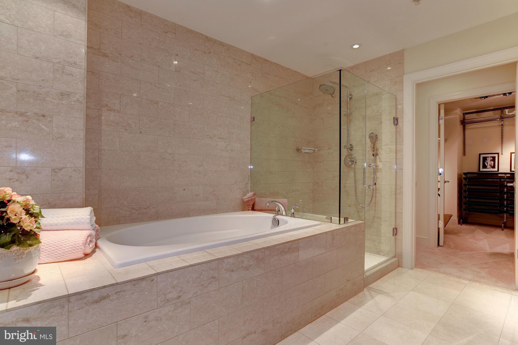 2425 L Street Northwest, Unit 340 Washington, DC 20037 - Photo 15 of 30 a spacious bathroom with a bathtub and a shower
