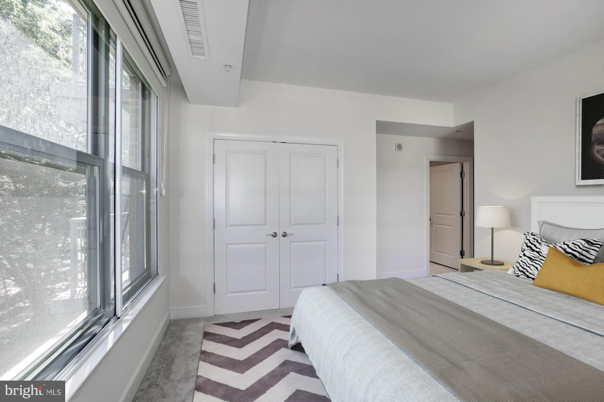 2425 L Street Northwest, Unit 340 Washington, DC 20037 - Photo 20 of 30 a bedroom with a bed and a window