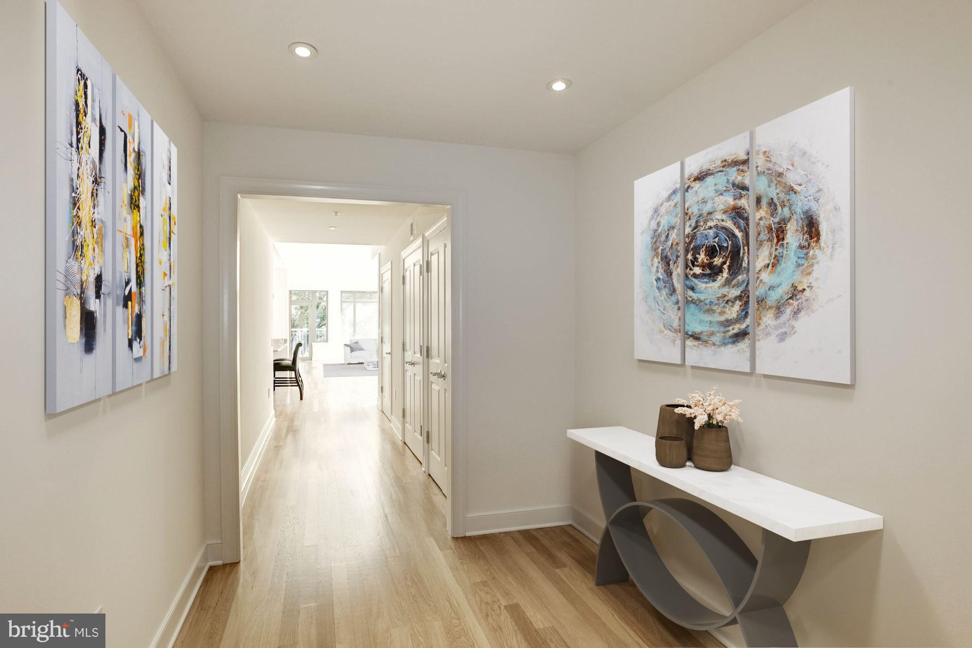 2425 L Street Northwest, Unit 340 Washington, DC 20037 - Photo 2 of 30 a view of a hallway with wooden floor and furniture