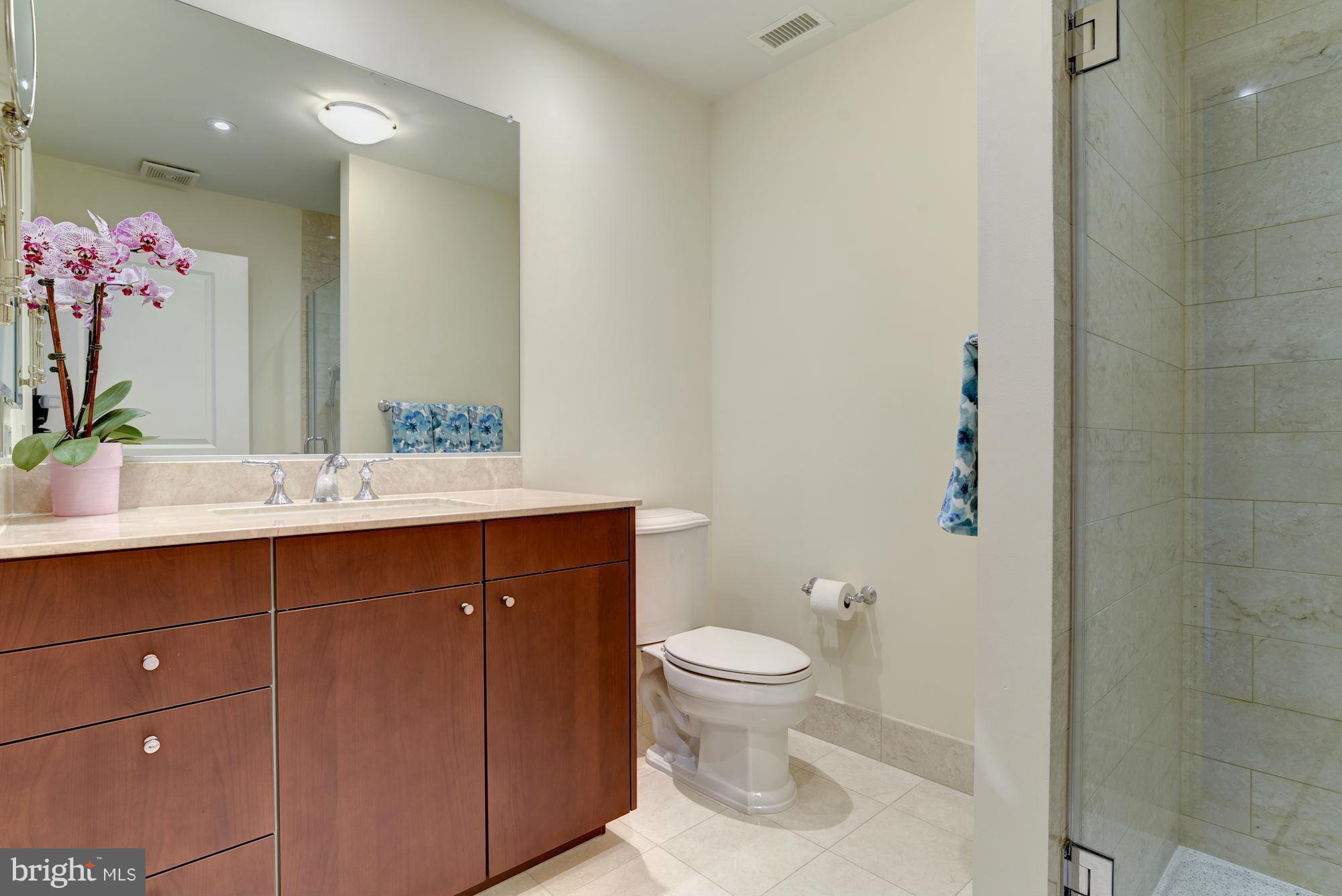 2425 L Street Northwest, Unit 340 Washington, DC 20037 - Photo 21 of 30 a bathroom with a sink vanity and a toilet