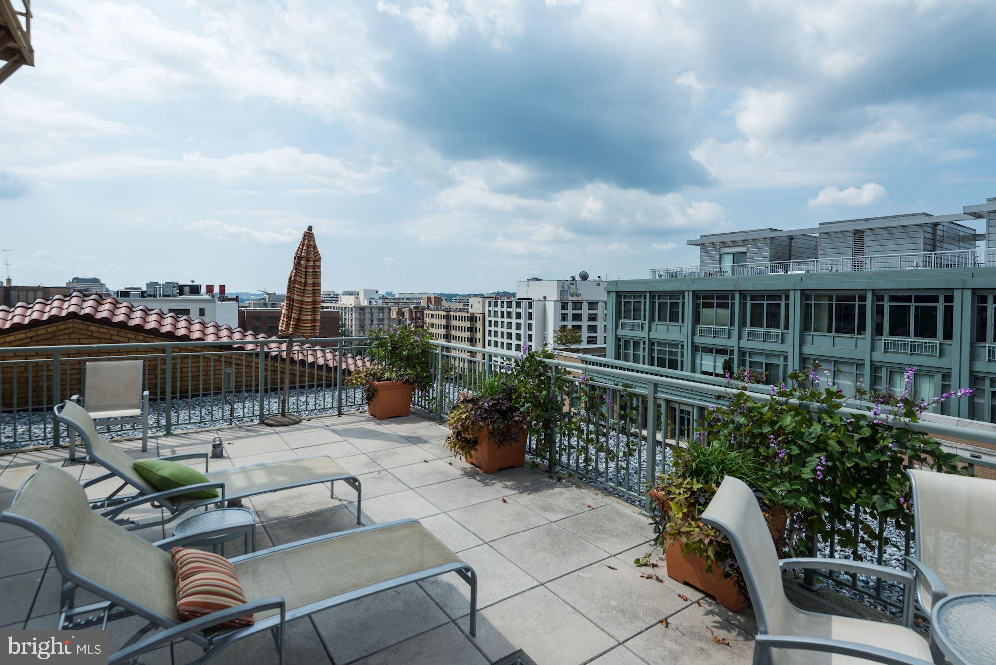 2425 L Street Northwest, Unit 340 Washington, DC 20037 - Photo 24 of 30 a roof deck with a table and chairs