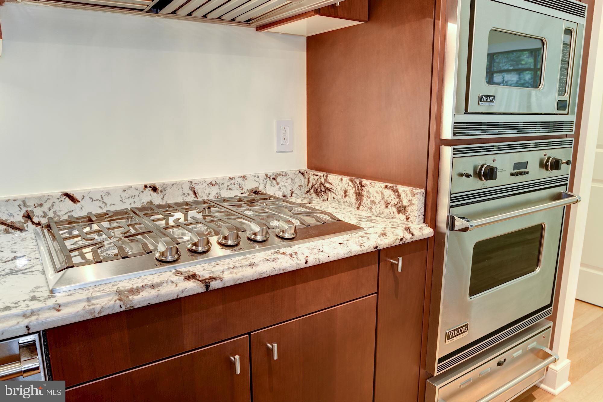 2425 L Street Northwest, Unit 340 Washington, DC 20037 - Photo 10 of 30 a kitchen with a stove and a microwave