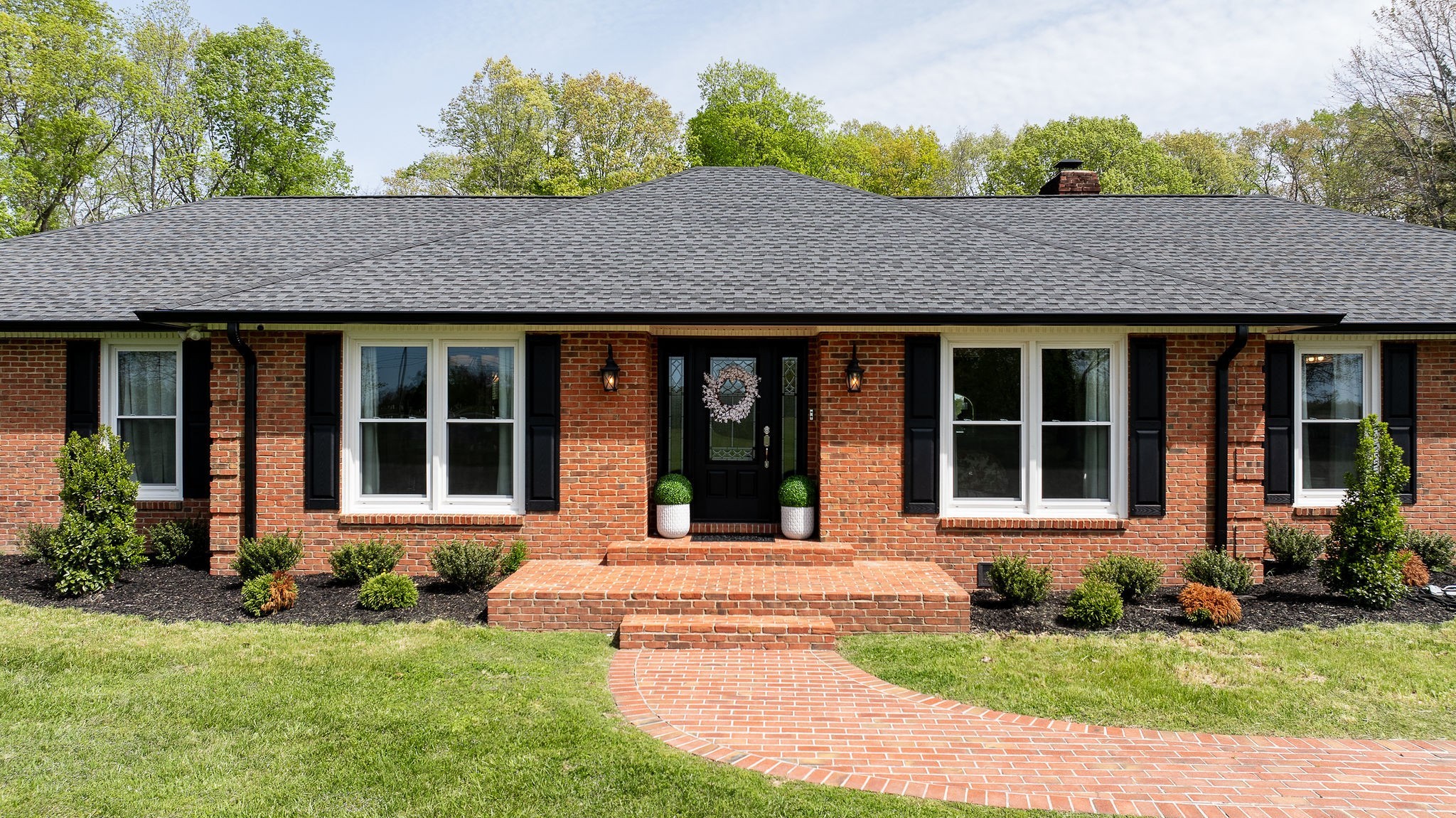 1747 Allen Ferry Road Smithville, TN 37166 - Photo 33 of 45 a view of brick house with a yard potted plants and a table