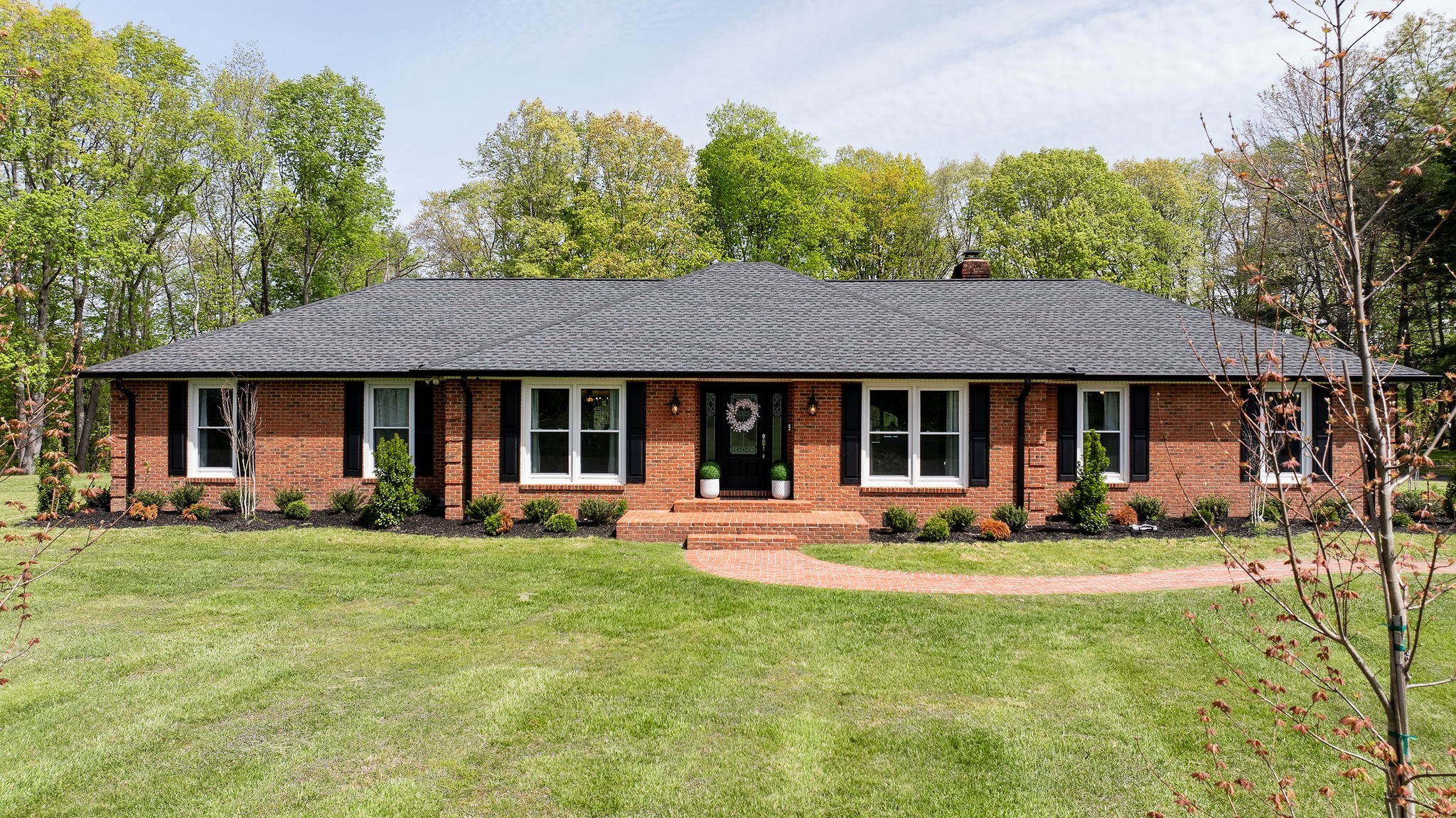 1747 Allen Ferry Road Smithville, TN 37166 - Photo 34 of 45 a front view of a house with a garden and trees