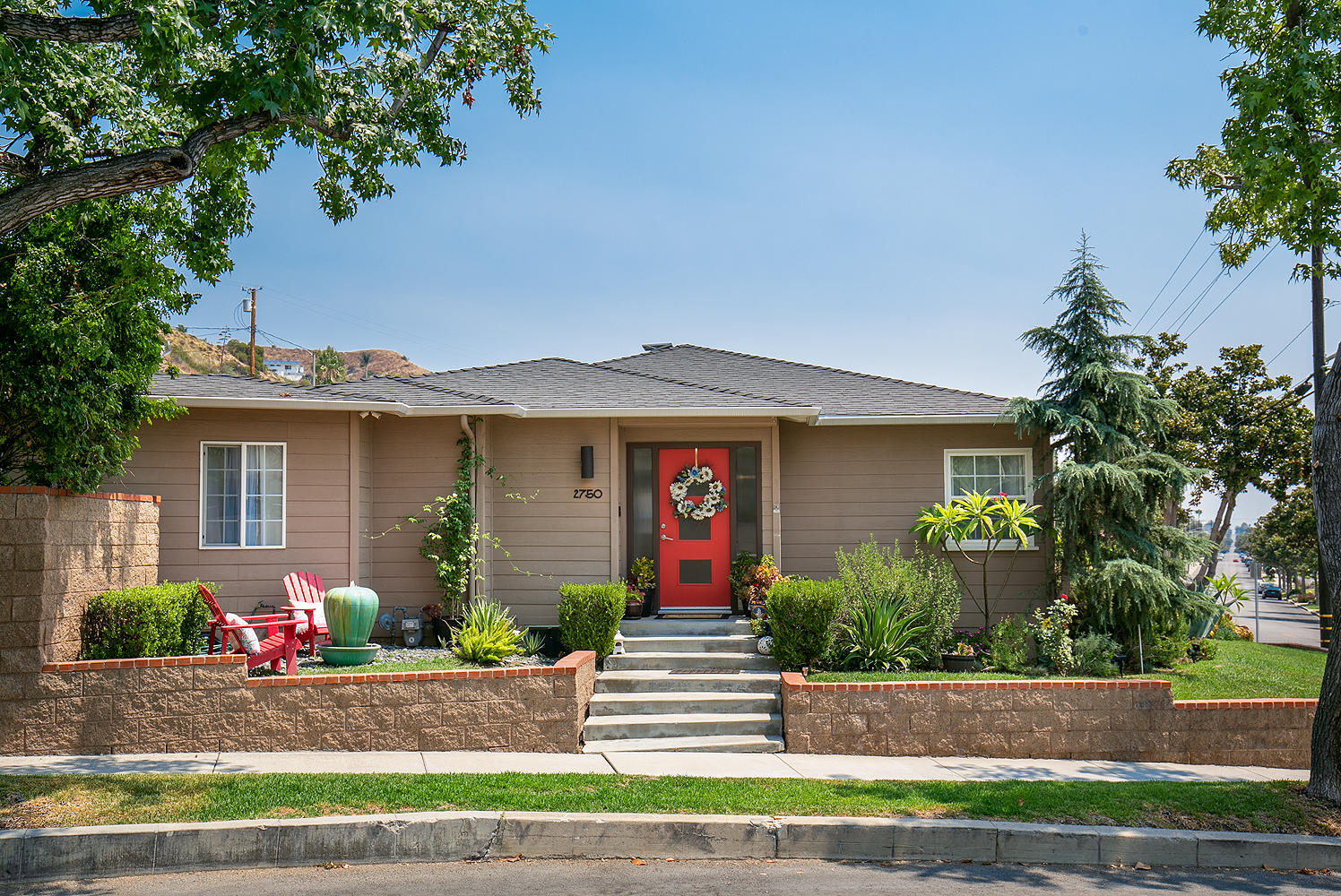 2750 North Kenneth Road Burbank, CA 91504 - Photo 1 of 32 a front view of a house with a yard and a garage