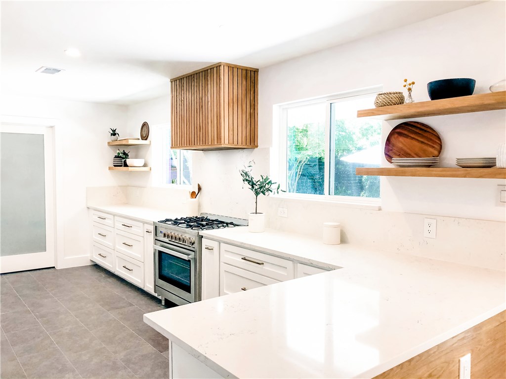 a kitchen with a stove a sink and a refrigerator