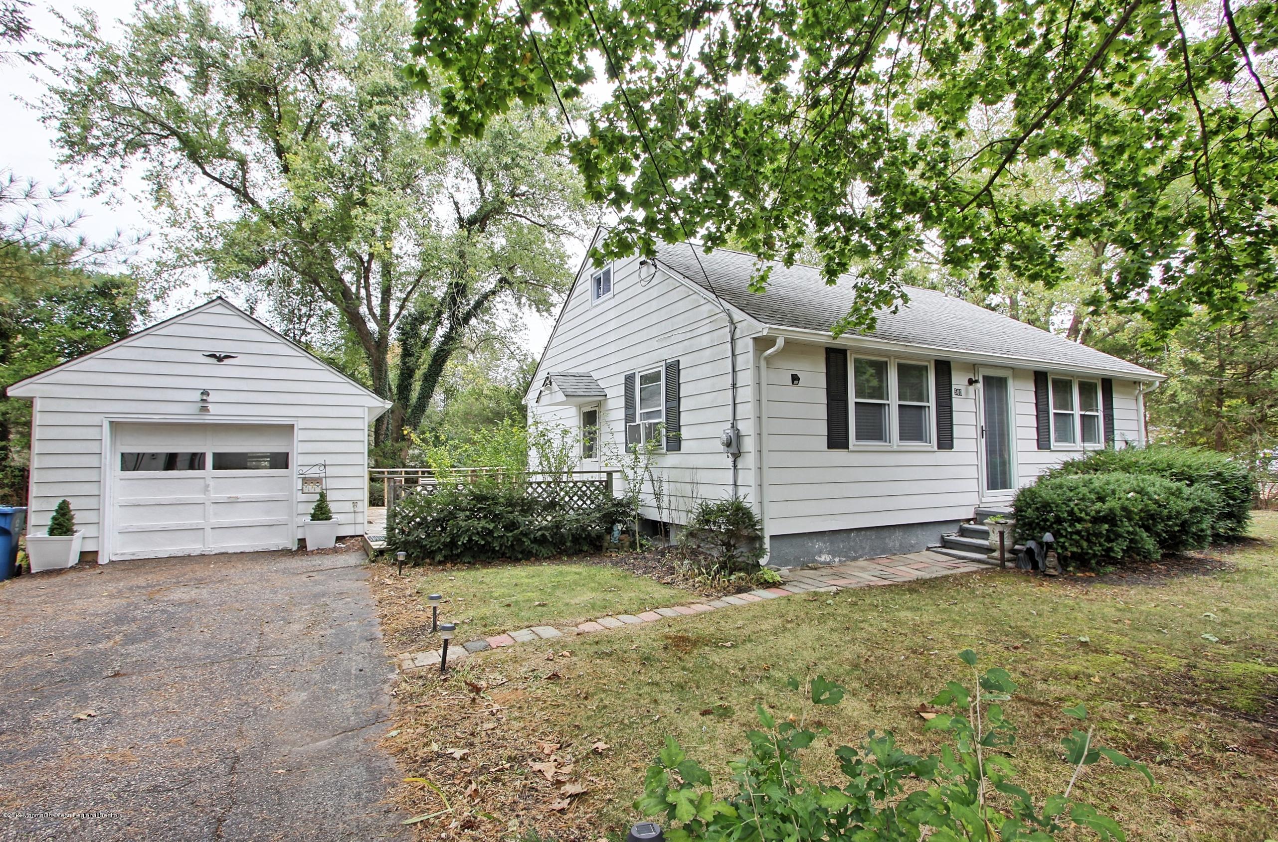 a view of a yard in front of a house with large trees