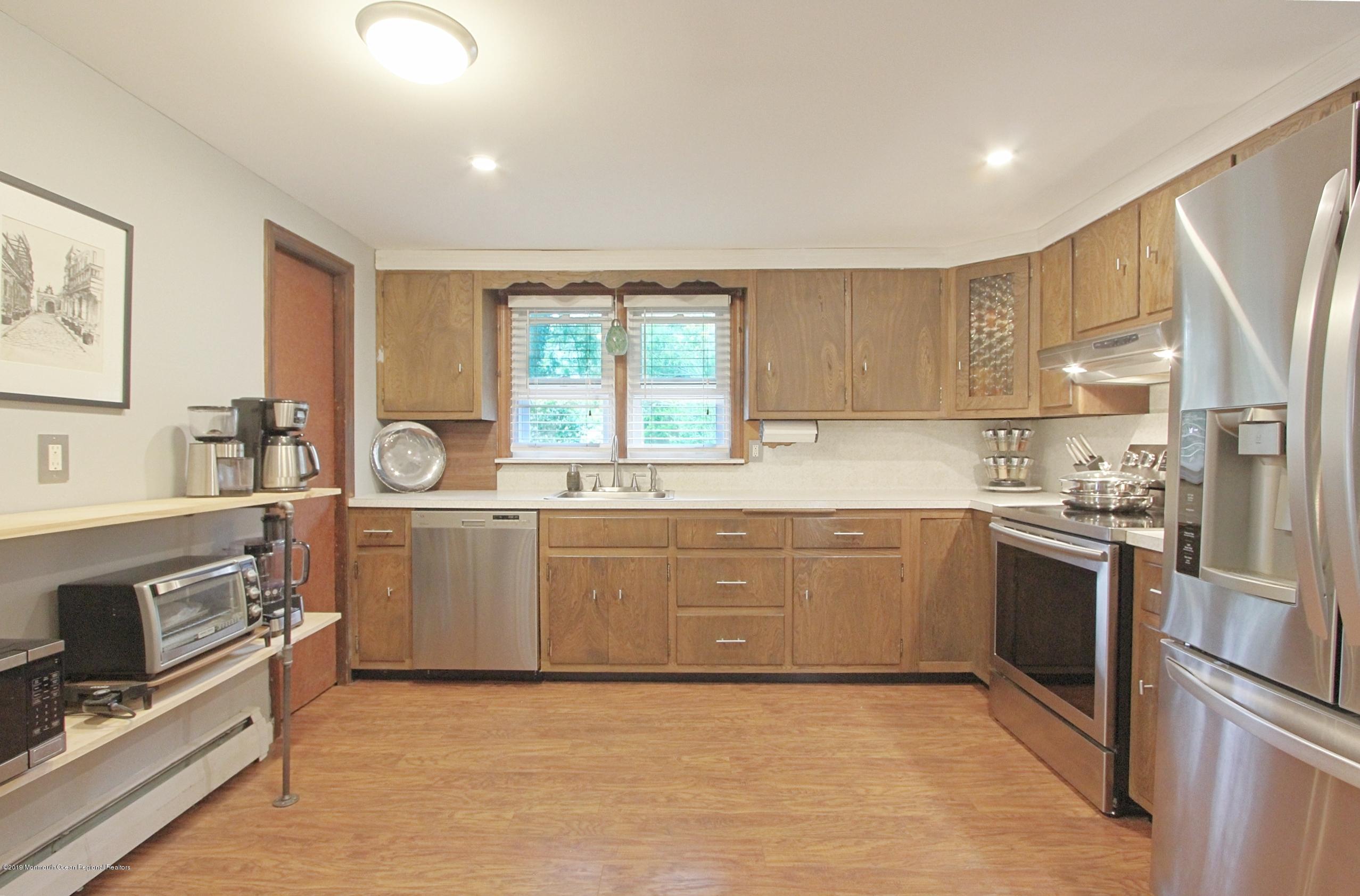 500 Hyson Road Jackson, NJ 08527 - Photo 6 of 30 a large kitchen with granite countertop a stove top oven sink and cabinets