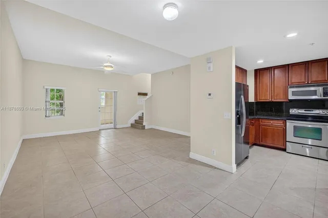 a view of a kitchen with a sink and a refrigerator