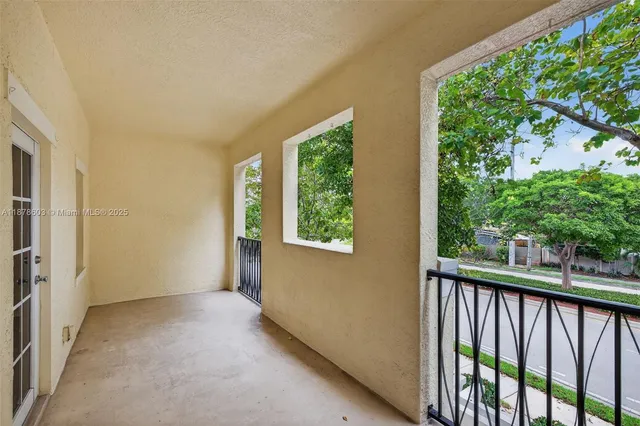 an empty room with wooden floor chandelier fan and windows