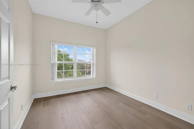 a view of entryway and hall with a ceiling fan