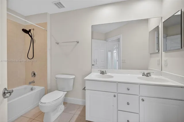 a bathroom with a sink mirror and toilet