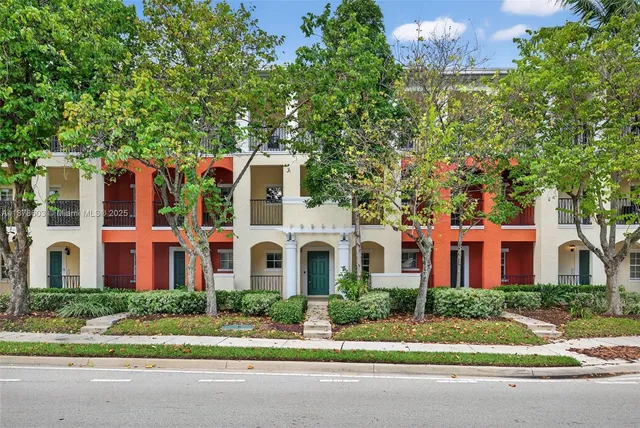 a view of a lake with a yard and a large tree