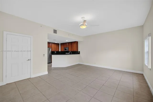 an empty room with a empty space and windows