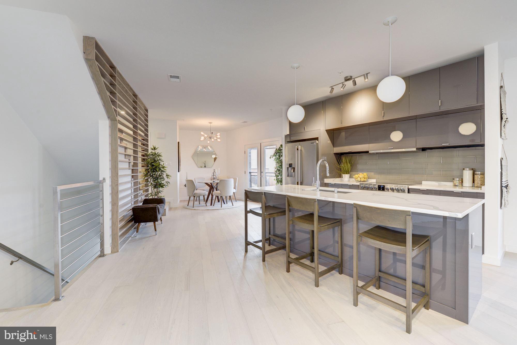 1869 Corcoran Street Northeast, Unit B Washington, DC 20002 - Photo 12 of 30 a open kitchen with a table and chairs