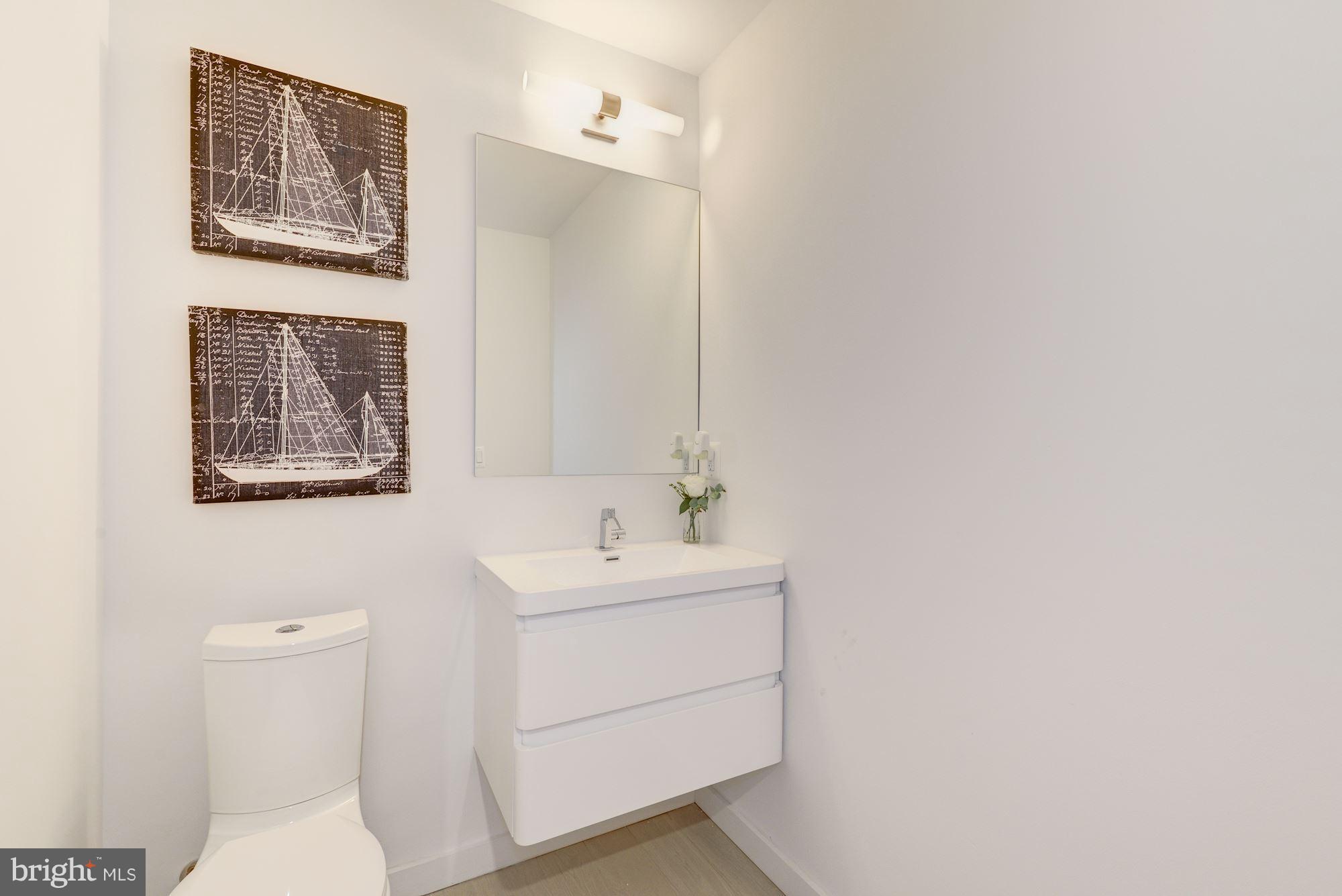 1869 Corcoran Street Northeast, Unit B Washington, DC 20002 - Photo 19 of 30 a bathroom with a sink mirror and toilet