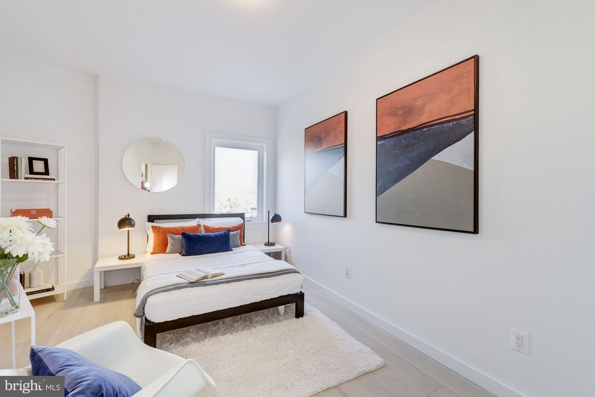 1869 Corcoran Street Northeast, Unit B Washington, DC 20002 - Photo 23 of 30 a bedroom with a bed and wall painting