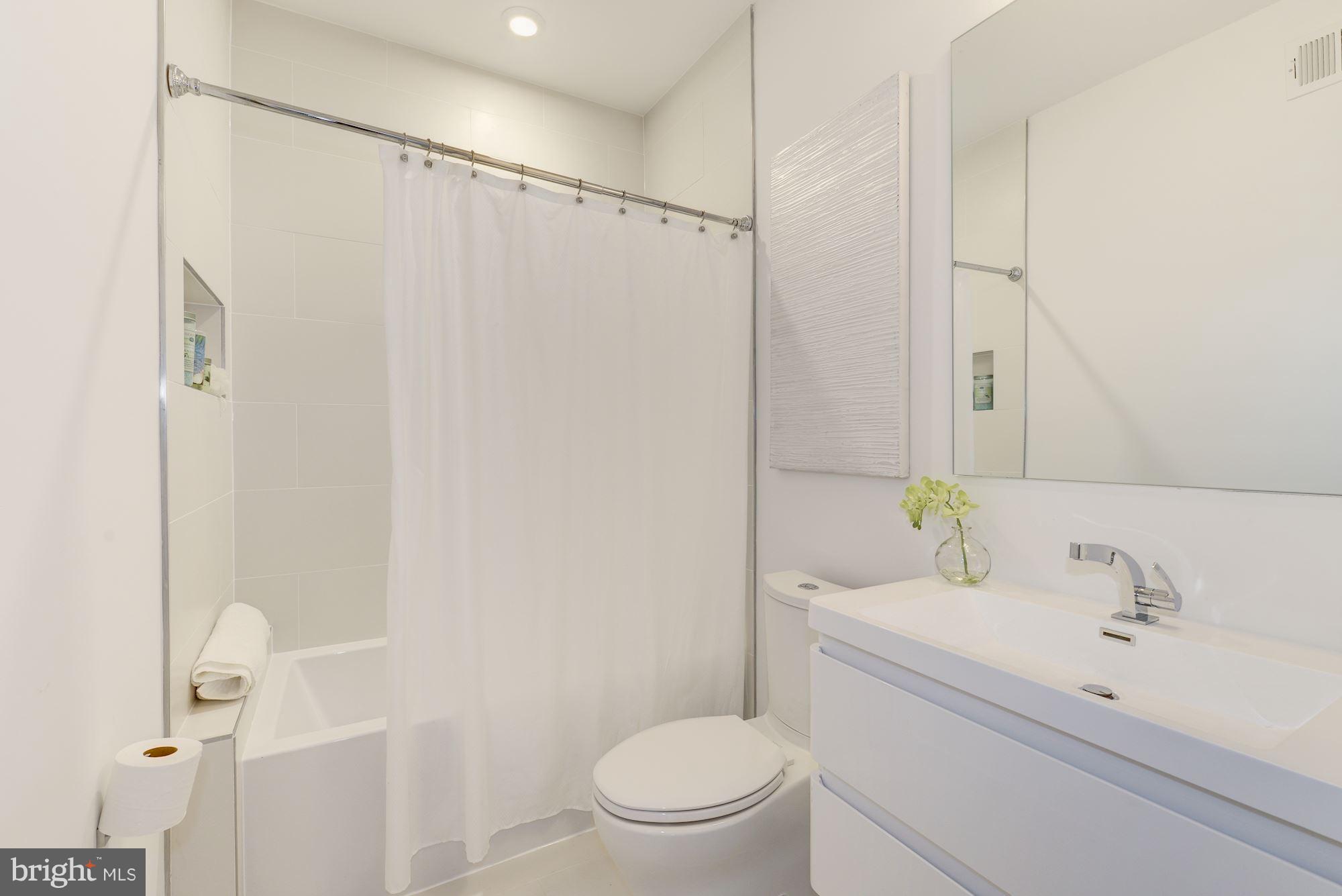 1869 Corcoran Street Northeast, Unit B Washington, DC 20002 - Photo 26 of 30 a bathroom with a sink a toilet and shower
