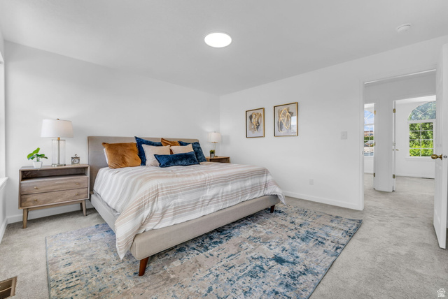 1147 West State Road Lehi, UT 84043 - Photo 16 of 31 Spacious bedroom featuring light neutral wall tones, plush gray carpeting, and a flush-mount ceiling light