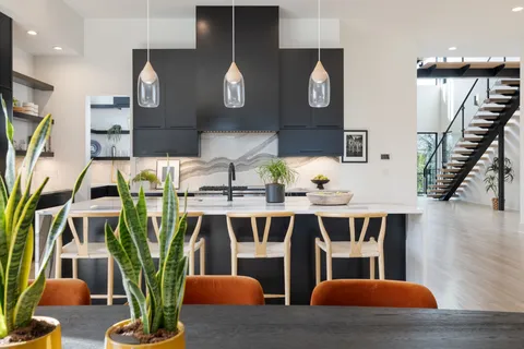 a view of a big room with wooden floor and windows