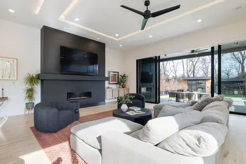 a bedroom with a bed a window and a flat screen tv