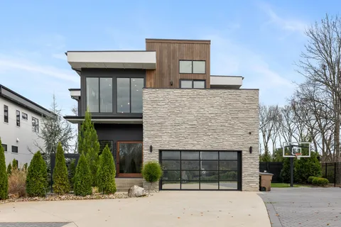 a kitchen with stainless steel appliances granite countertop a sink a stove and a refrigerator